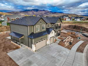 View of front of house featuring a mountain view and a garage