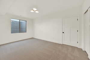 Empty room featuring light colored carpet