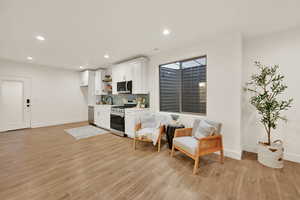 Sitting room with light hardwood / wood-style flooring and sink