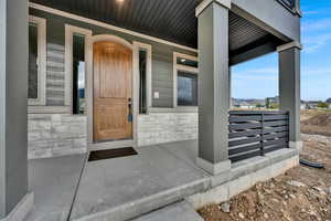 View of exterior entry with covered porch