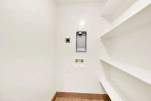 Laundry room with hardwood / wood-style flooring, washer hookup, and hookup for an electric dryer