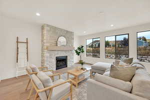 Living room with a fireplace and light wood-type flooring