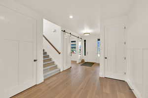 Entrance foyer featuring light wood-type flooring and a barn door