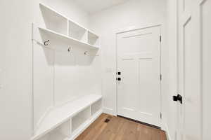 Mudroom with light hardwood / wood-style floors