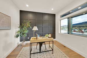 Home office with a mountain view and light wood-type flooring