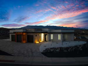 View of front of home with a garage and a mountain view