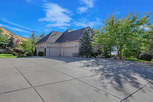 View of side of property featuring a garage and a mountain view