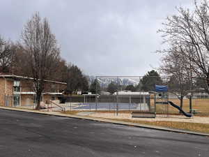 Clubhouse, pool, and playground area.