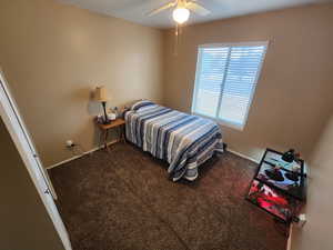 Carpeted bedroom with ceiling fan