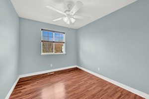 Spare room featuring ceiling fan and hardwood / wood-style floors