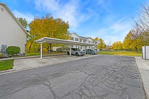 View of parking with a yard