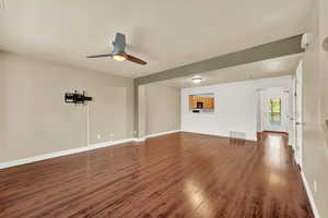 Spare room with ceiling fan and dark wood-type flooring