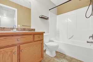 Full bathroom featuring shower / bathing tub combination, vanity, toilet, and tile patterned floors