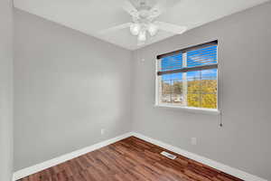 Empty room featuring hardwood / wood-style floors and ceiling fan