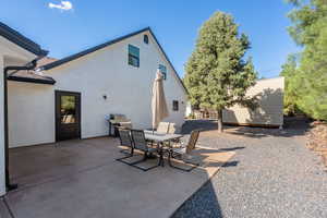 View of patio with a grill