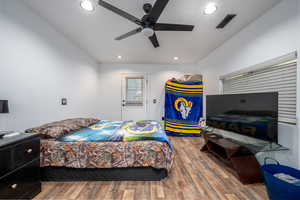 Bedroom featuring ceiling fan and hardwood / wood-style flooring