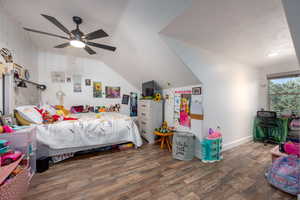 Bedroom featuring lofted ceiling, dark hardwood / wood-style floors, and ceiling fan