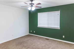 Spare room with light carpet and ceiling fan