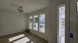 Entrance foyer with a textured ceiling and light wood-type flooring