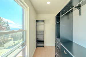 Walk in closet featuring light hardwood / wood-style flooring