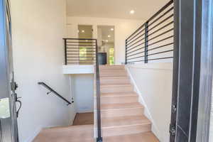 Stairs featuring hardwood / wood-style floors