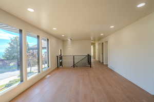 Spare room with a wealth of natural light and light hardwood / wood-style flooring