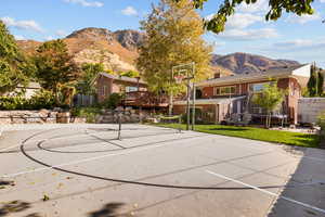 View of sport court featuring a yard and a mountain view