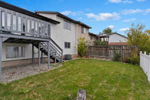 View of yard featuring central air condition unit and a deck