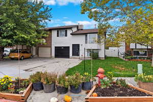 View of front of home with a front yard and a garage