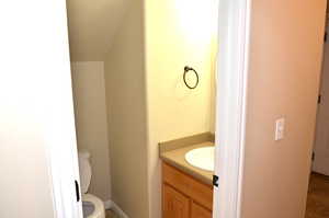 Bathroom featuring toilet, vanity, and tile patterned flooring