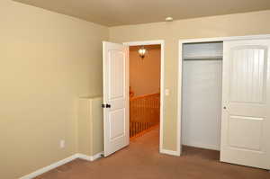 Unfurnished bedroom with a closet and carpet floors