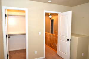 Unfurnished bedroom featuring a closet and light colored carpet