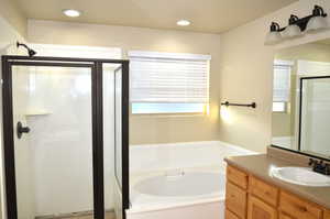 Bathroom with vanity and separate shower and tub