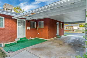 View of patio with a garage and a carport