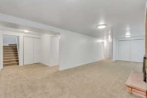 Basement with light carpet