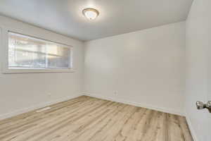 Spare room featuring light wood-type flooring