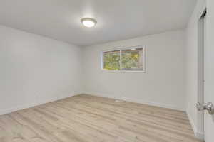 Empty room featuring light hardwood / wood-style flooring