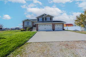 View of front facade with a front yard and a garage