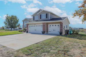 View of property exterior featuring a yard and a garage