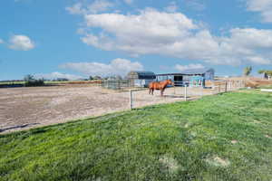 View of yard featuring a rural view and an outdoor structure