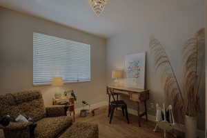 Home office featuring a chandelier