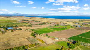 Drone / aerial view featuring a water and mountain view and a rural view