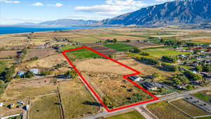 Birds eye view of property with a water and mountain view and a rural view