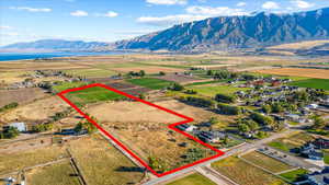 Birds eye view of property featuring a water and mountain view