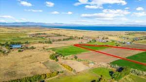 Birds eye view of property with a water and mountain view