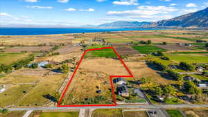 Birds eye view of property featuring a water and mountain view