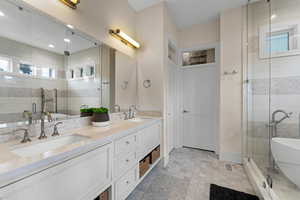 Bathroom featuring vanity and plus walk in shower