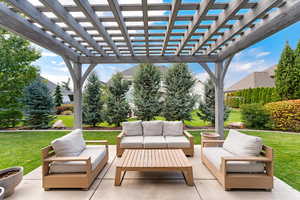 View of patio featuring an outdoor hangout area and a pergola