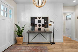 Foyer with hardwood / wood-style floors and plenty of natural light