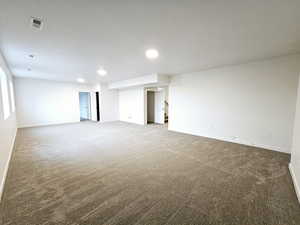 Unfurnished room featuring carpet and a textured ceiling